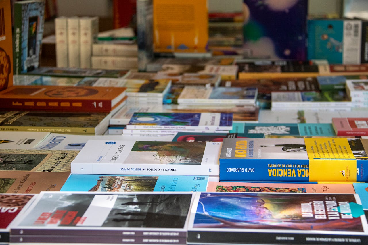 An assorted collection of books arranged on a table in Madrid, showcasing diverse genres and covers.